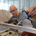Mikhail Golubev, a design engineer, operating and controlling a 3D printer at the university’s composite materials lab.